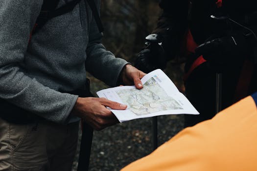 A hiker using a compass and map in the wilderness