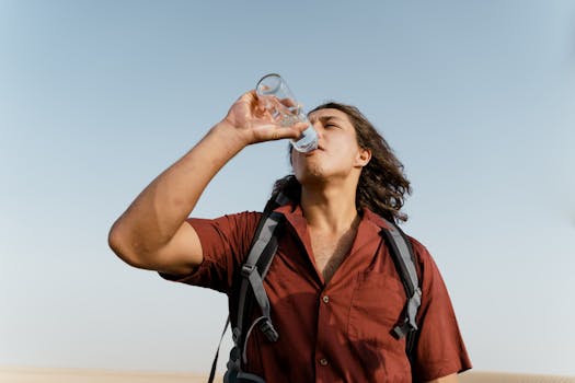 hiker drinking from a portable water filter